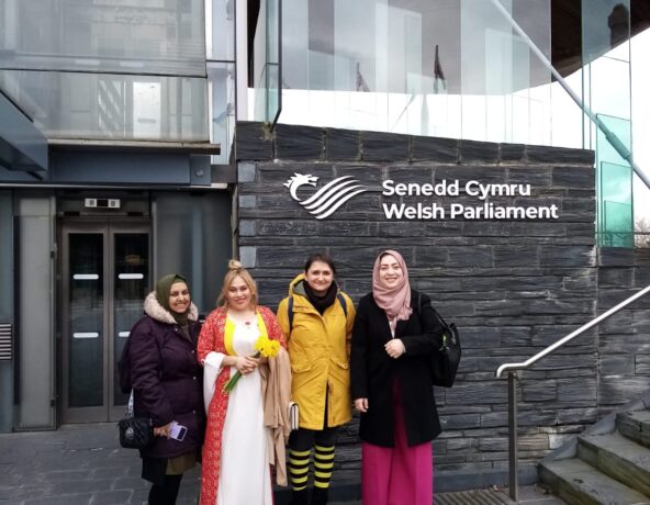 Four women standing outside the Welsh Parliament