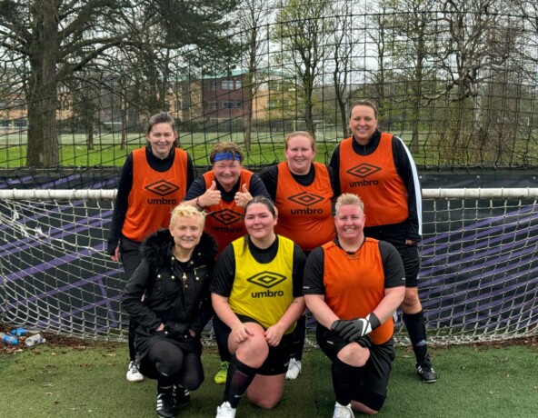 Ladies football team photo in front of goal