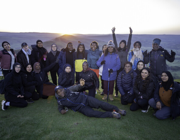 Group of young people on the summit of a hill