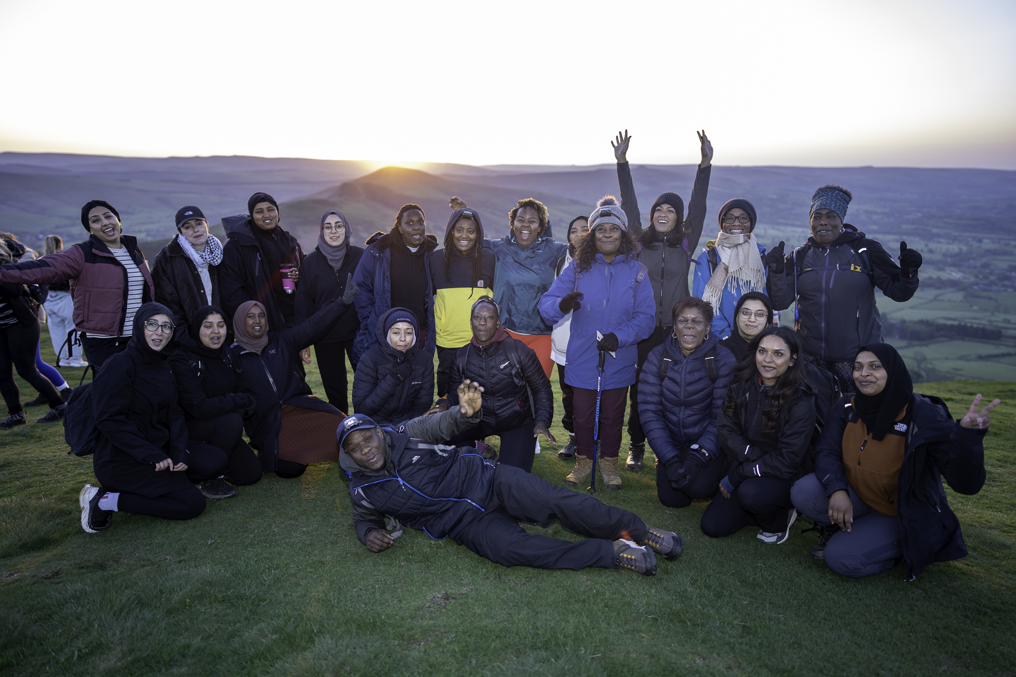 Group of young people on the summit of a hill