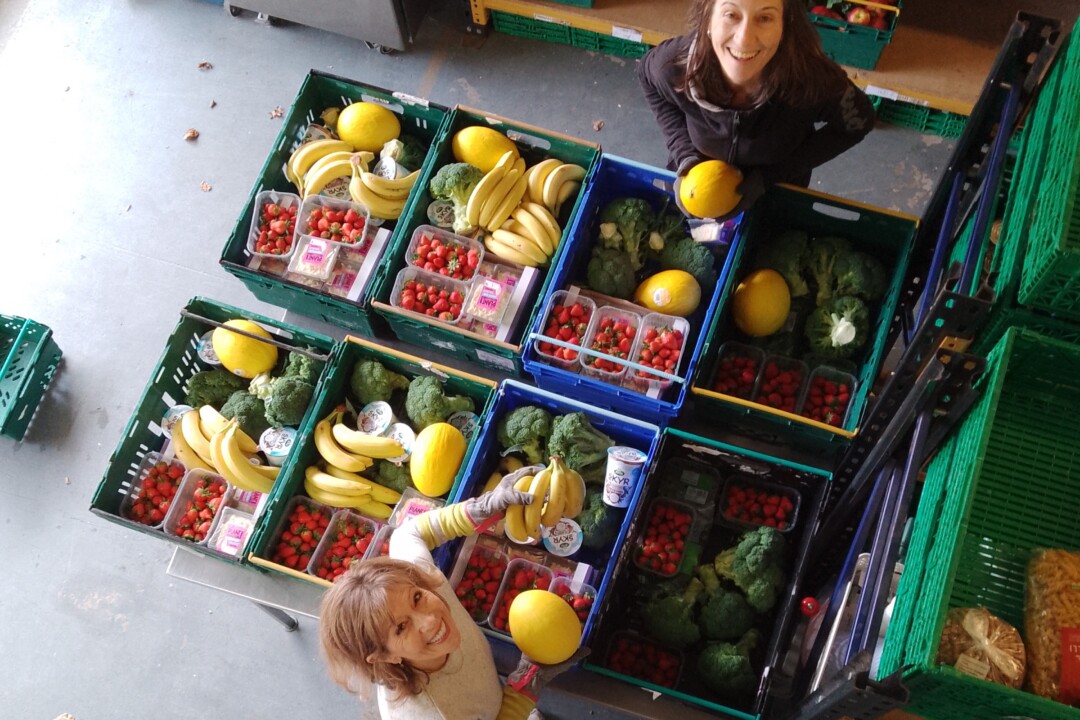 Two volunteers helping at Cambridge Sustainable Food distribution centre.